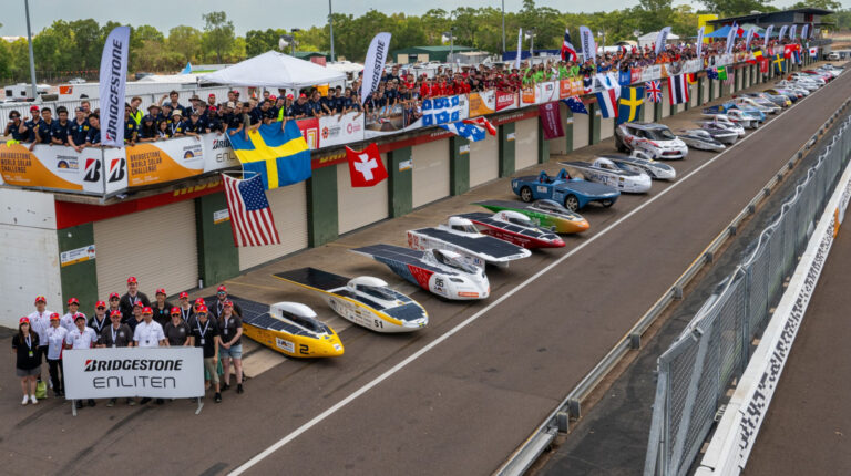 Bridgestone to launch Enliten tires with new recycled materials at 2025 World Solar Challenge Sporty looking electric cars sit lined up on the race track at World Solar Challenge event.