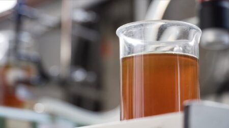 Opinion: How Michelin’s ResiCare helped make 100 million tires A glass beaker in a chemical laboratory, three-quarters full with a brown liquid.