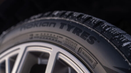 Side view of a Nokian Tyres tire fitted to a car wheel with the company logo visible