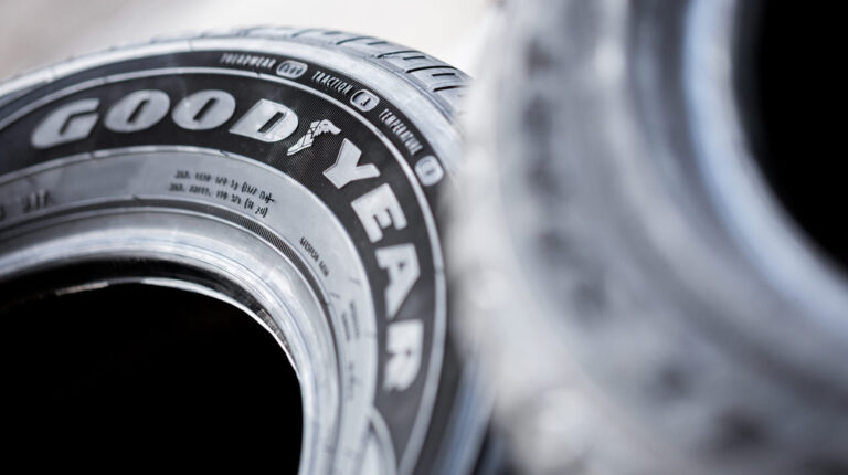 A tire lies on its side with Goodyear written on the sidewall