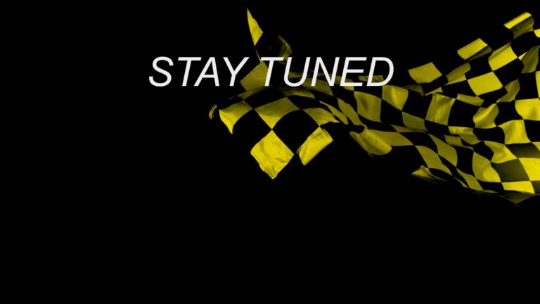 yellow checkered flack with "stay tuned" text in front