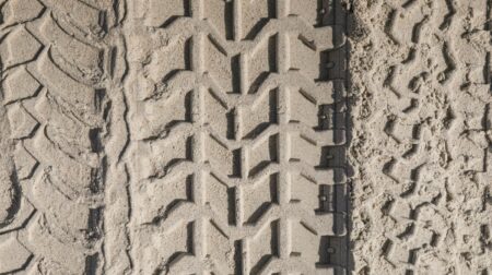 BKT Europe revises organizational structure Large tire tracks in a light brown sand