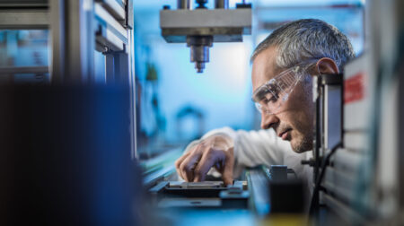 OPINION: Harmonization is the superpower tire emissions research needs now A scientist wearing safety glasses and a white lab coat looks at a sample on a table