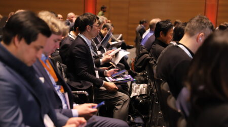 Attendees sit in rows at a packed conference presentation at Tire Technology Expo