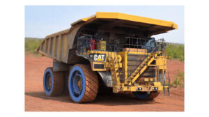 The GACW Air Suspension Wheel on a Cat off-highway vehicle in a dusty work environment.