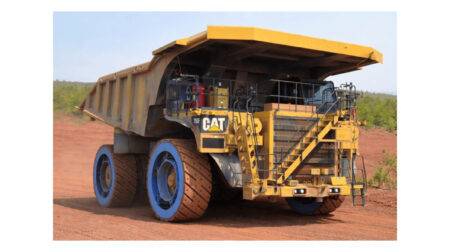 The GACW Air Suspension Wheel on a Cat off-highway vehicle in a dusty work environment.