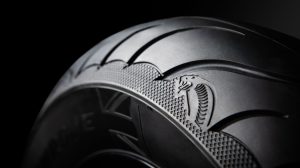 Close-up of the Cobra Chrome tire against a black background.