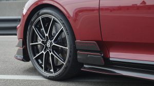 Close up of the Pirelli P Zero tire on a red Bentley Supersports